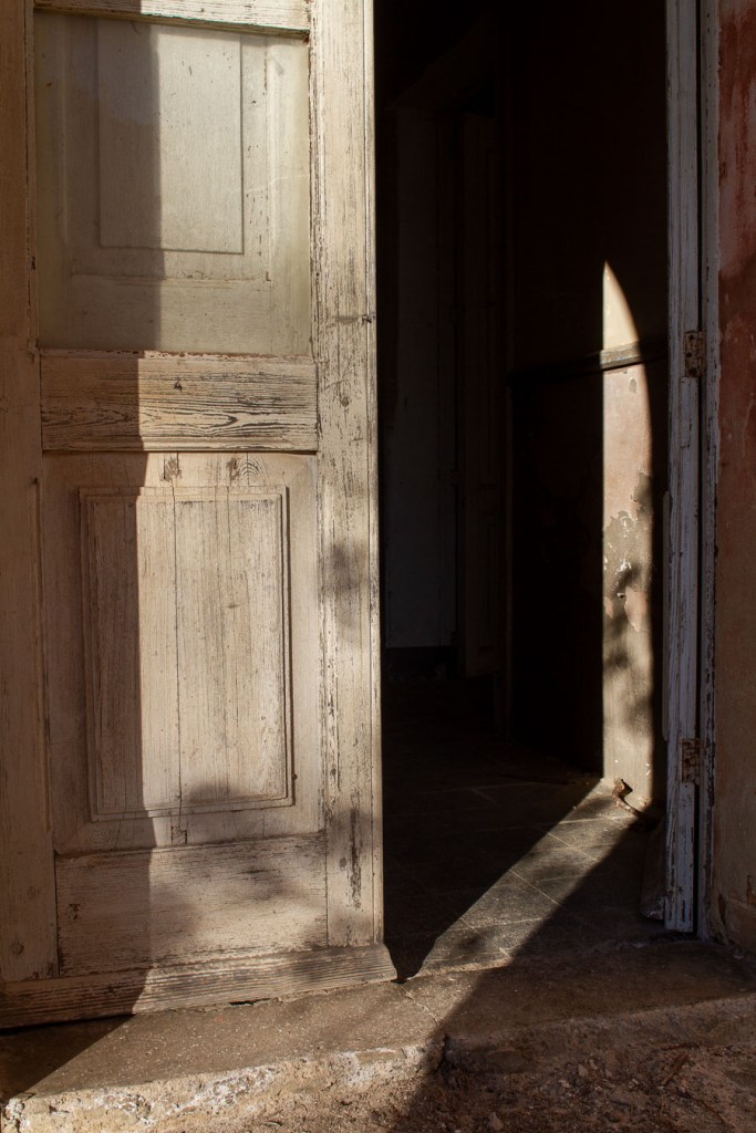Diagonal light and shadow on interior wall of abandoned building, Ferruzzano, Calabria