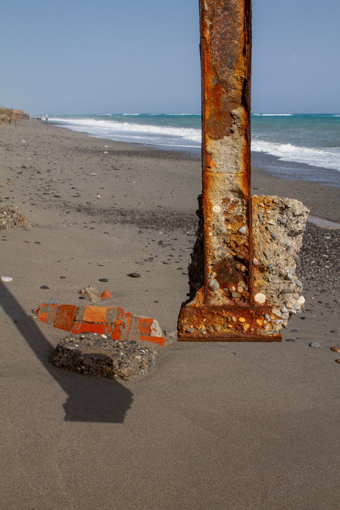 Suspended concrete block on a rusted metal post, San Pasquale beach, Bova Marina, Calabria